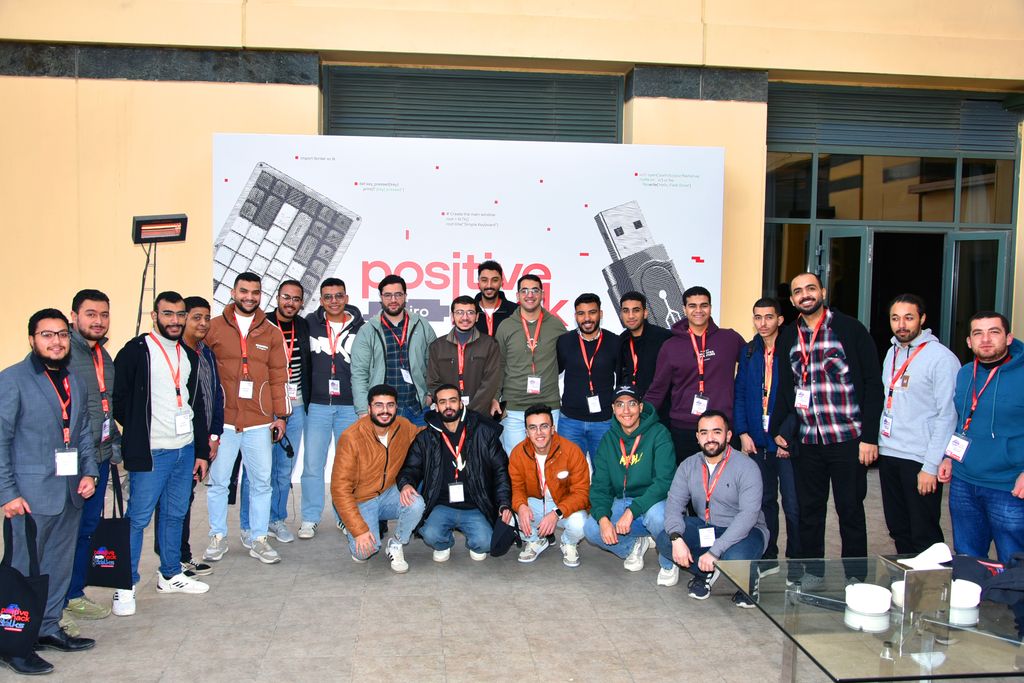 Attendees in a group photo in front of the Positive Hack Talks Cairo backdrop