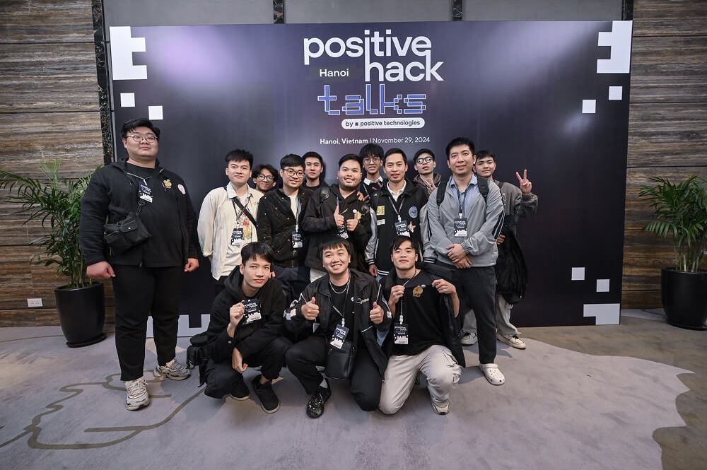 Group photo of attendees at the Positive Hack Talks Hanoi backdrop