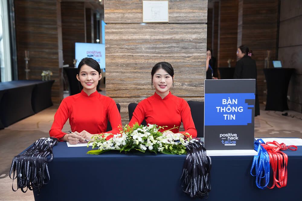 The information desk at the entrance, lanyards laid out on the table
