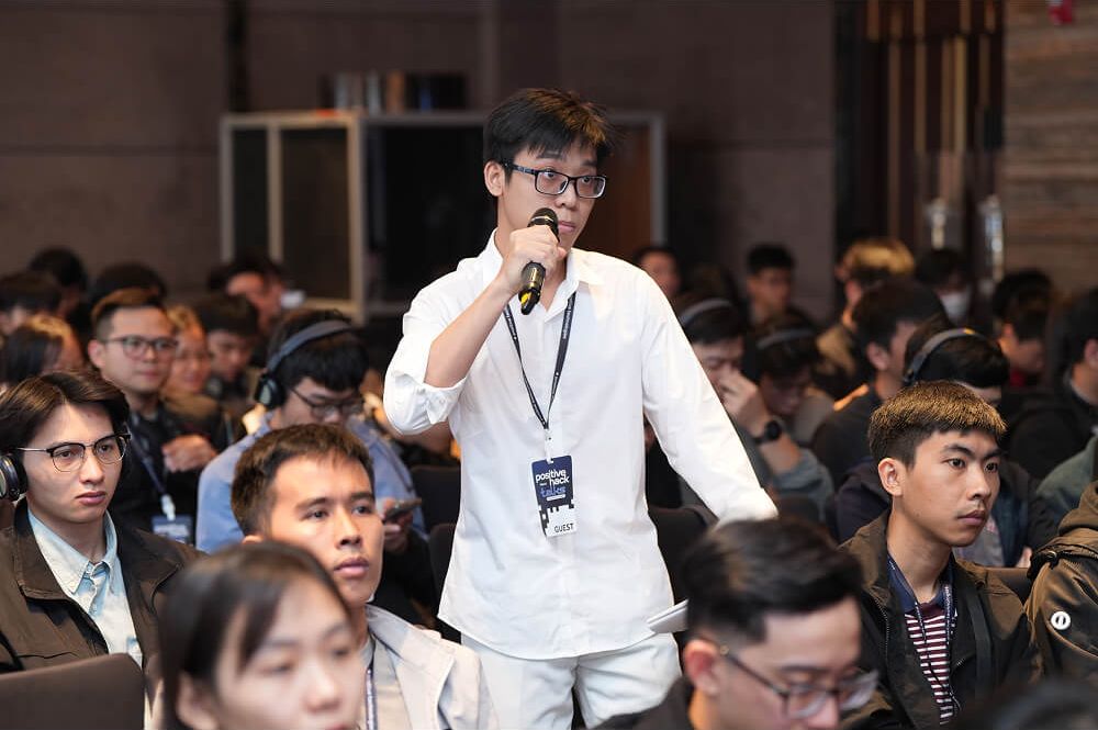 An attendee asks a question from the floor