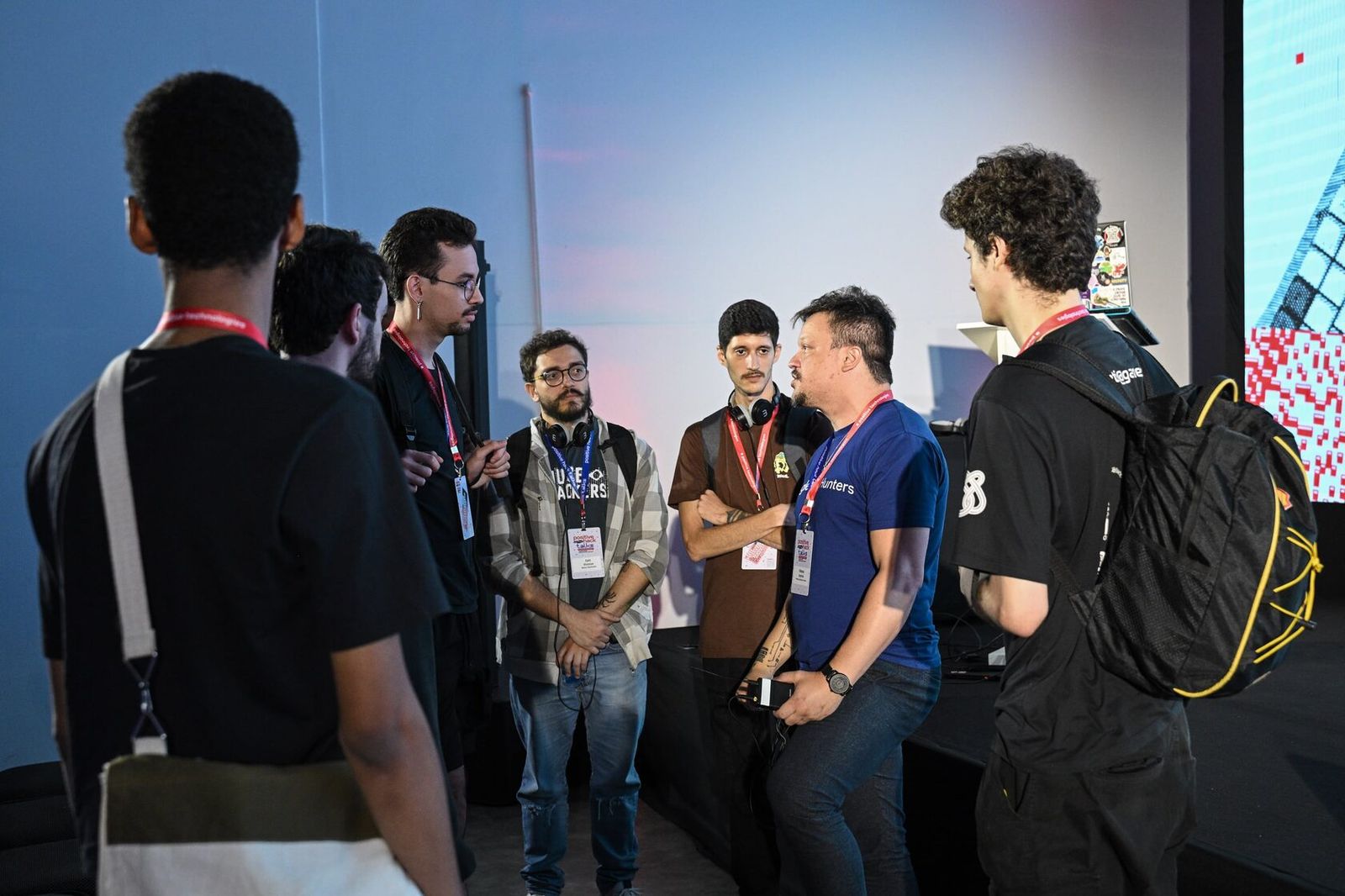 Attendees talking in a group by the stage
