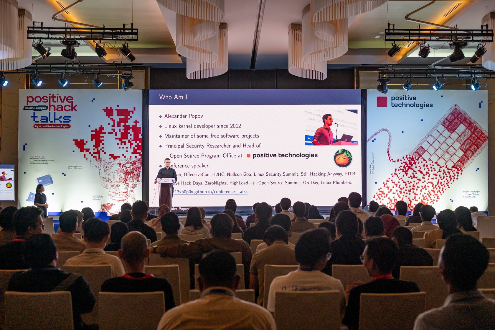 Positive Hack Talks community event — the hall during a talk